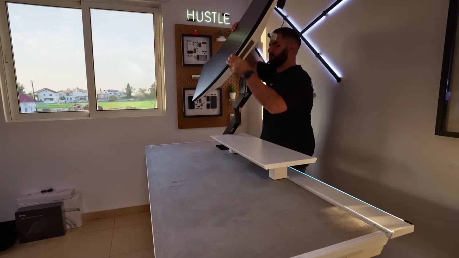 Peter mounting a monitor during a desk build