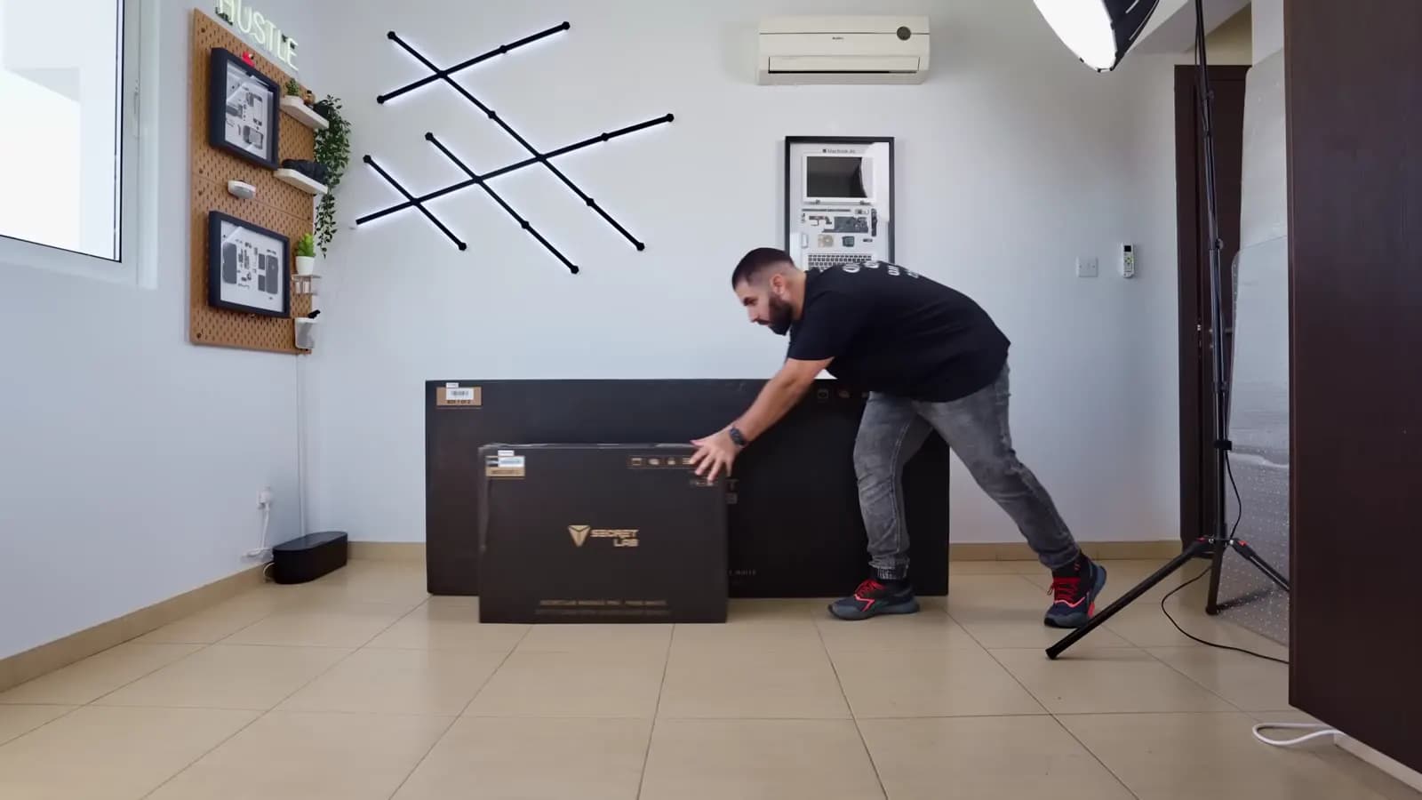 Peter unboxing a new desk in the studio